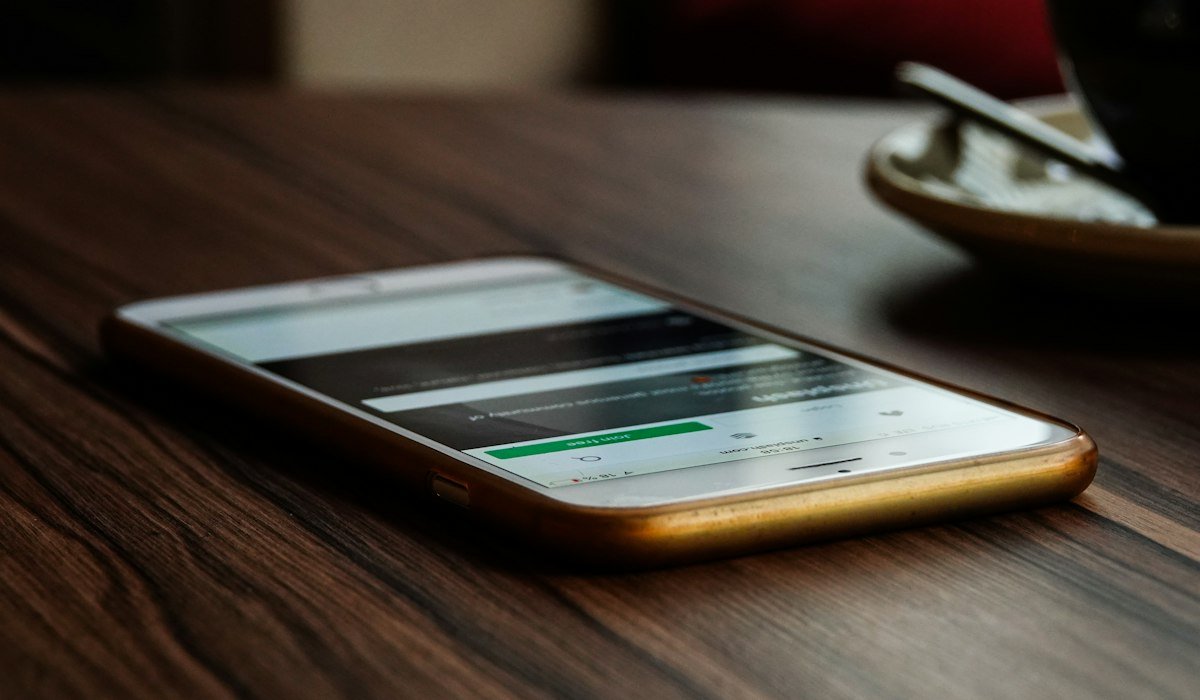 Smartphone on a desk illustrating how to check a du mobile number in the UAE